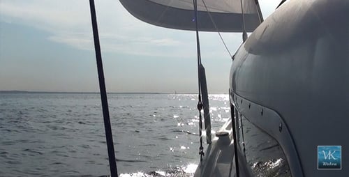 Sailboat Sailing Across Water on a Bright Day