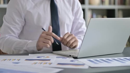 Close Up Shoot of Businessman Using Laptop and Making Report
