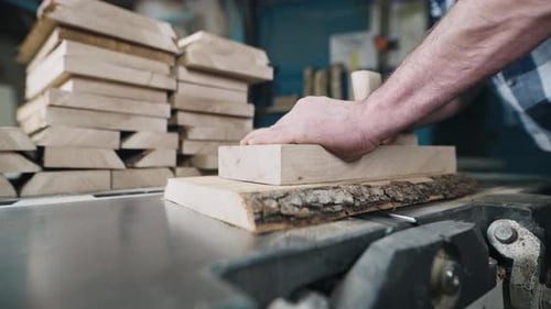 Man Cutting Wood on Saw Table