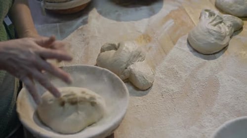 Adults Kneading and Shaping Bread Dough in Kitchen