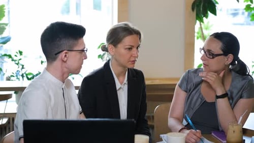 Business Colleagues Working Together at Cafe