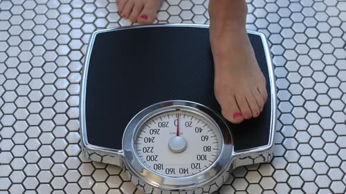 Bare Feet Step on Bathroom Scale to Weigh