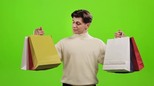 Young Adult Holding Shopping Bags on Green Screen