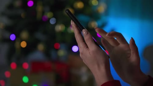 Online Congratulation or Ordering Gift on the Eve of the New Year Girl Touches the Screen of a