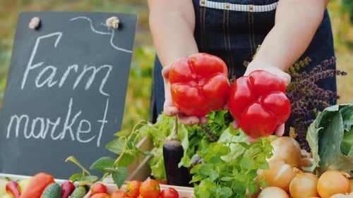 Woman Selling Fresh Vegetables at Farmers Market