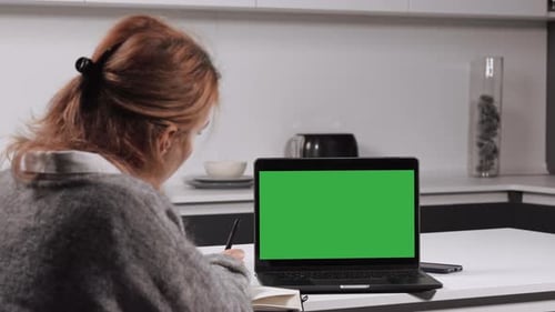 Woman Working at Home on Laptop with Green Screen