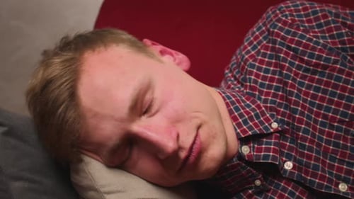 Close Up Young Caucasian Man Came Home After Work Flopped Down on Sofa at Home