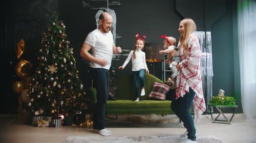 Happy Family Dancing Together During Christmas