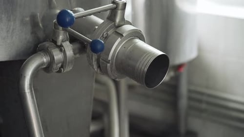 Drain pipe for finished cheese. Equipment for making cheese in the production room. Close-up