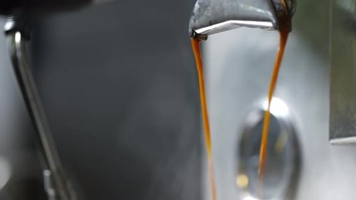 Fresh Espresso Pouring from Machine Close Up
