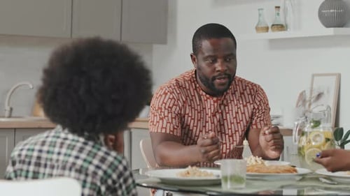 African American Man Having Dinner with Family at Home
