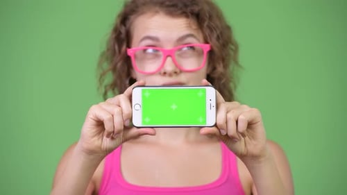 Woman Holds Smartphone with Green Screen for Compositing