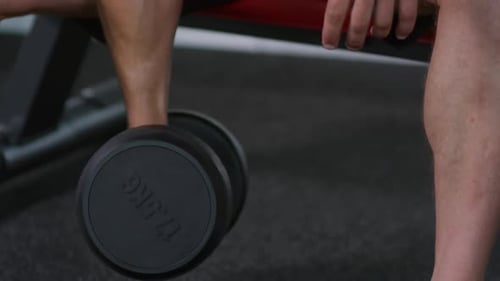 Man Training with Dumbbell during Gym Workout