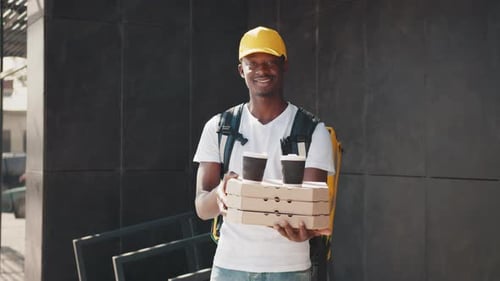 Food Delivery Employee With Pizzas and Coffees