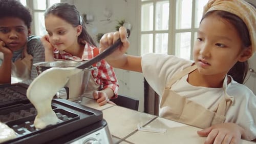 Children Making Waffles Together in the Kitchen