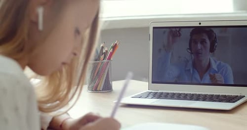 Girl Studies During Online Class with Teacher