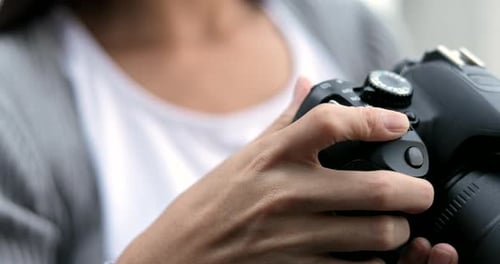 Hands Adjusting Camera Settings Close-Up