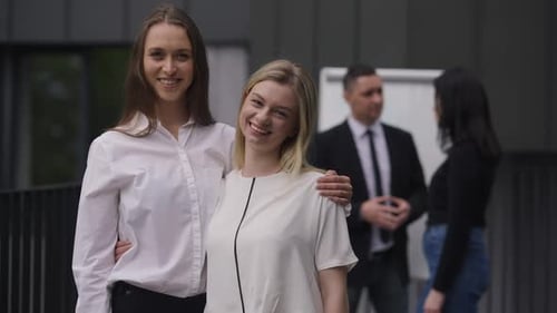 Smiling Businesswomen Together Outside of Office Building