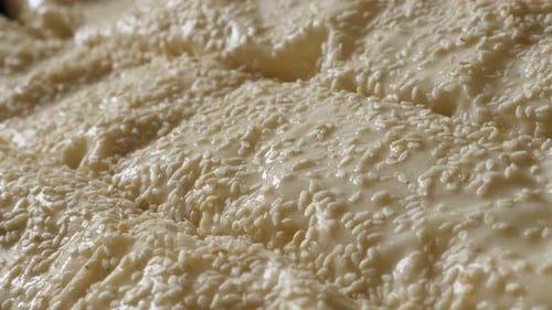Close-Up of Dough Covered in Sesame Seeds