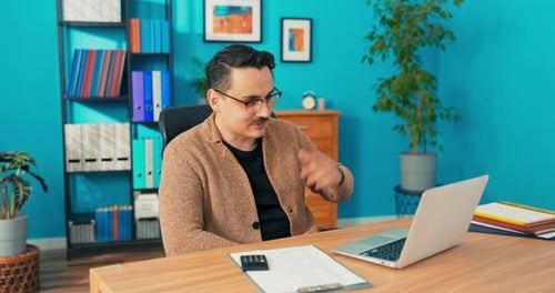 Video Call Via Webcam in Company Office Man with Glasses Sits Behind Desk in Front