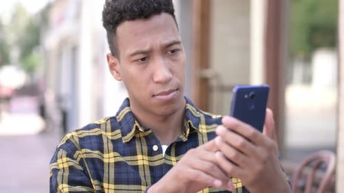 Young Adult Using Mobile Phone in Urban Setting