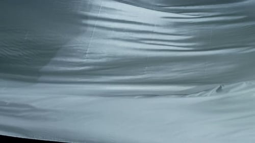 Light Blue Silky Fabric Flowing Gently in Waves