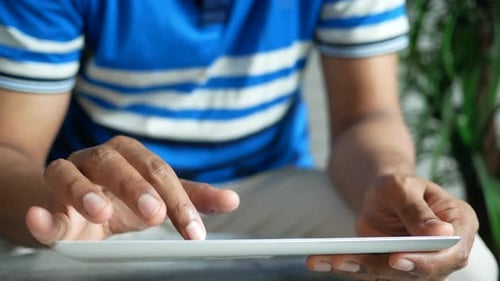 Man in Casual Dress Using Digital Tablet White Sited