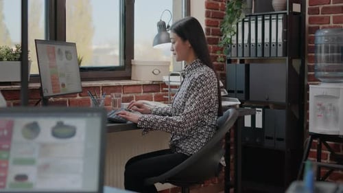 Woman Working at Computer in Modern Office