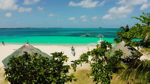 Tropical Daco Island with a Sandy Beach and Tourists