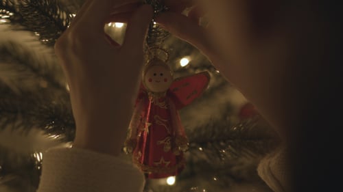 Decorating Christmas Tree With Angel Ornament