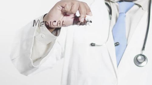 Doctor Writes Medical Tourism on Clear Surface