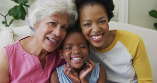 Portrait of happy african american grandmother with adult daughter and granddaughter