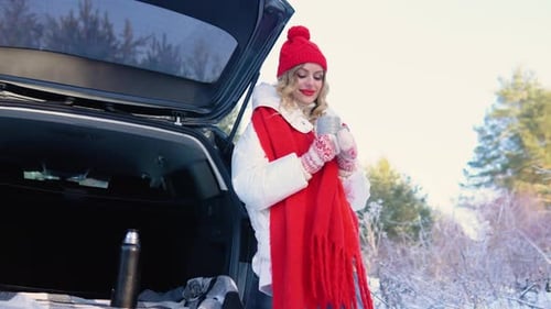 Woman Enjoying Hot Drink in Winter Wonderland Scene