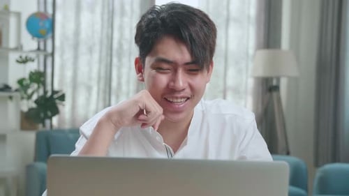 Close Up Of Asian Man Student Having Video Call While Using Computer To Study Online At Home