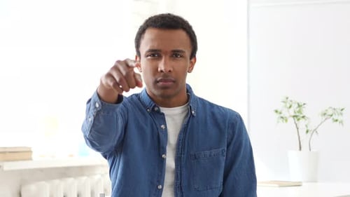 Serious Man Points at Camera in Studio