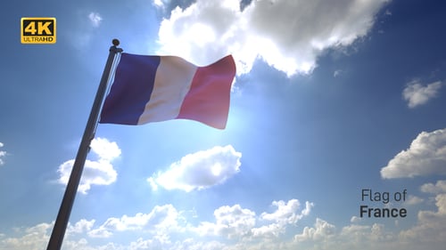 French Flag Waving In Bright Sunlight Against Blue Sky