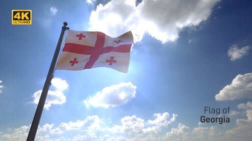 Georgian Flag Waving in Sunlight Against Blue Sky