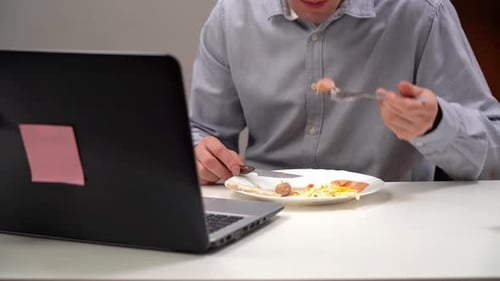 A Young Office Worker a Manager Eats His Diet in His Home Office During Isolation a Pandemic