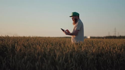 Stylish Man Farmer With Glasses Green Cap and Cream TShirt Doing a Selfie