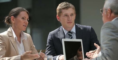 People Talking During Business Meeting at Table