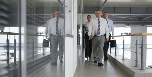Business Team Walking Confidently Through Modern Office