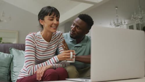 Couple Relaxing Together Watching Laptop Indoors