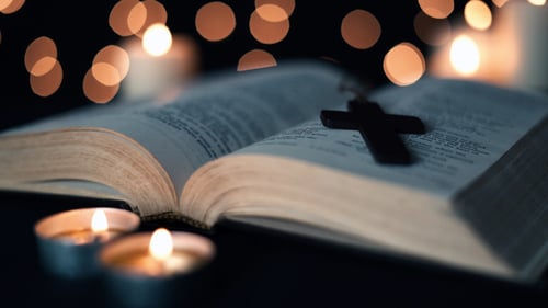 Close Up of Bible with Cross and Candles