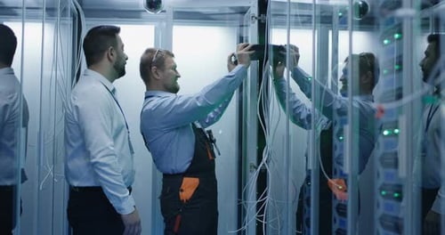 Two Men Performing Maintenance in a Data Center