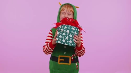 Excited Child Elf Receives a Christmas Present