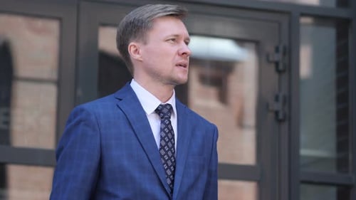 Man in Suit Checking Time on Smartwatch