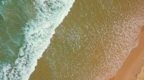 4K Aerial view of sea waves splashing tropical island beach in summer sunny day.
