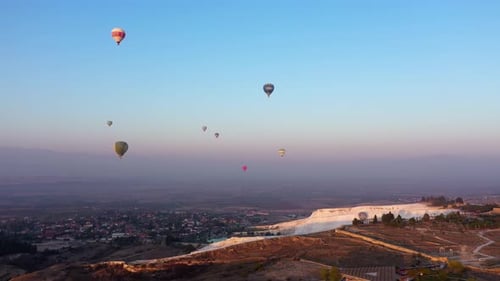 Landscape of Pamukkale Park and Hot Air Balloons in the Morning Sky