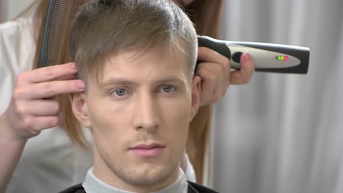 Man Gets Haircut by Stylist with Trimmer