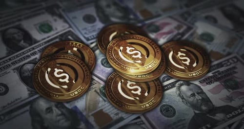 USDC Cryptocurrency Coins Rotating on US Dollar Bills Background